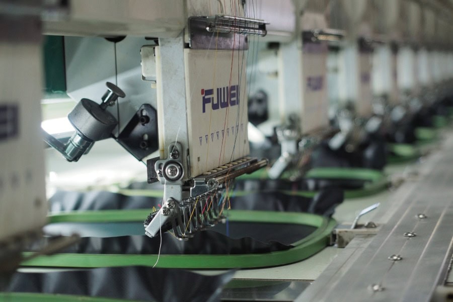 San Marcos embroidery machine printing a design onto custom merchandise