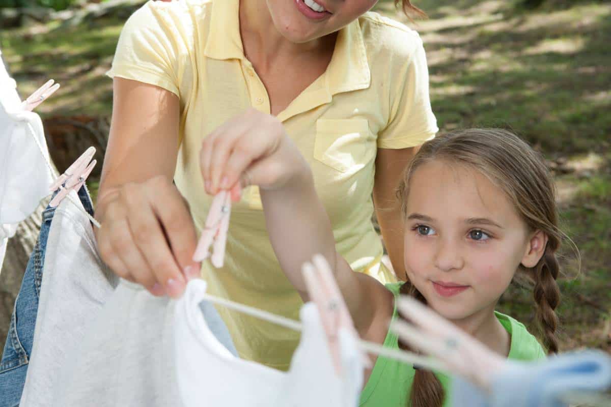 mother-and-daughter-hanging-clothes-to-dry