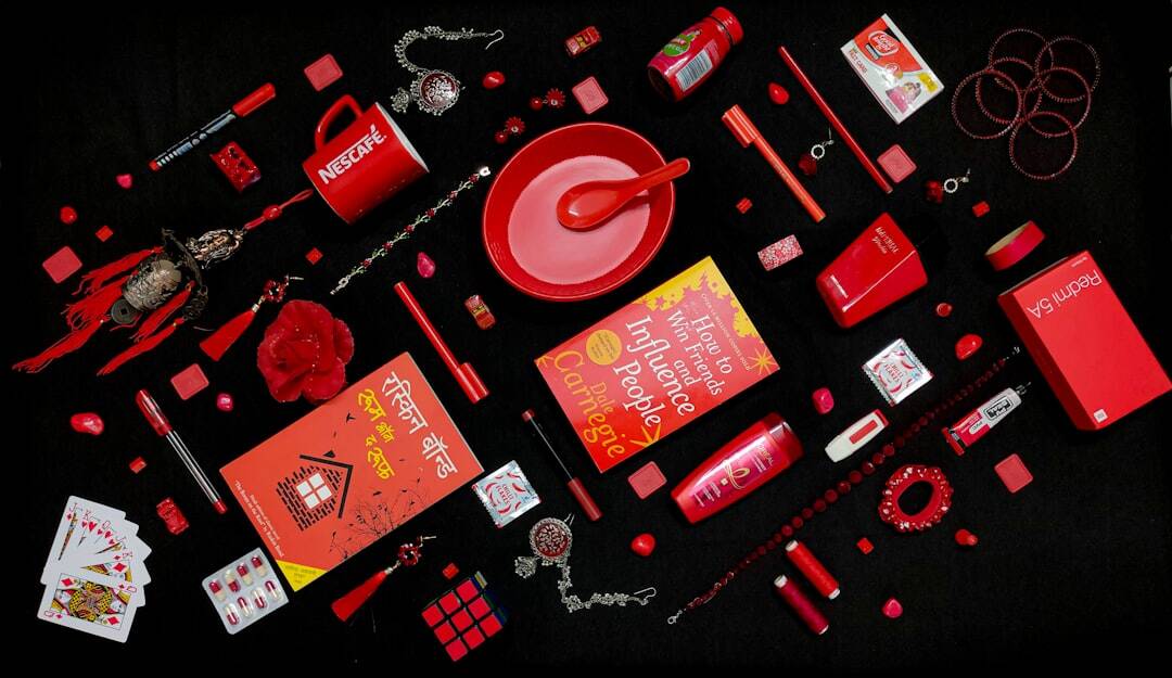 Array of red San Marcos promotional products on a black background.